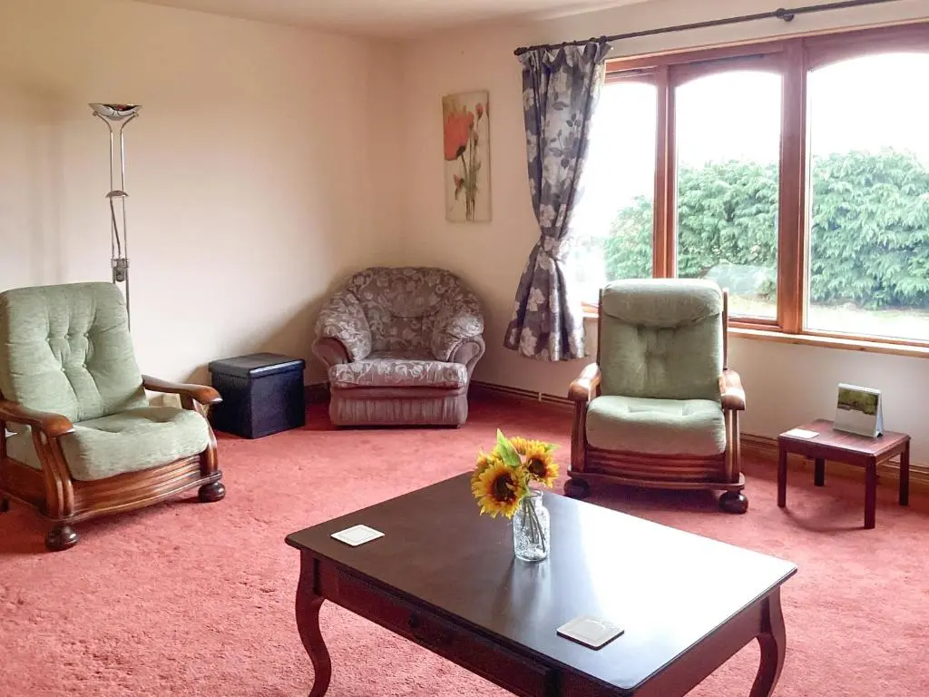 a living room with two chairs and a coffee table at The Junipers in Tain