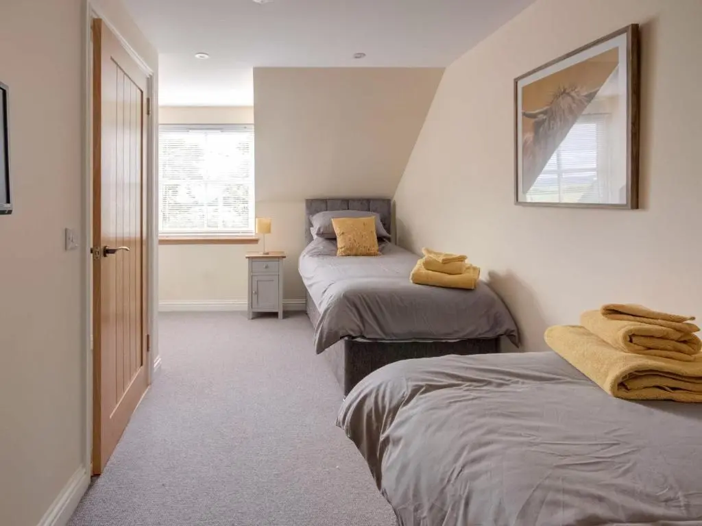 a bedroom with two beds with towels on them at Darna House in Tain