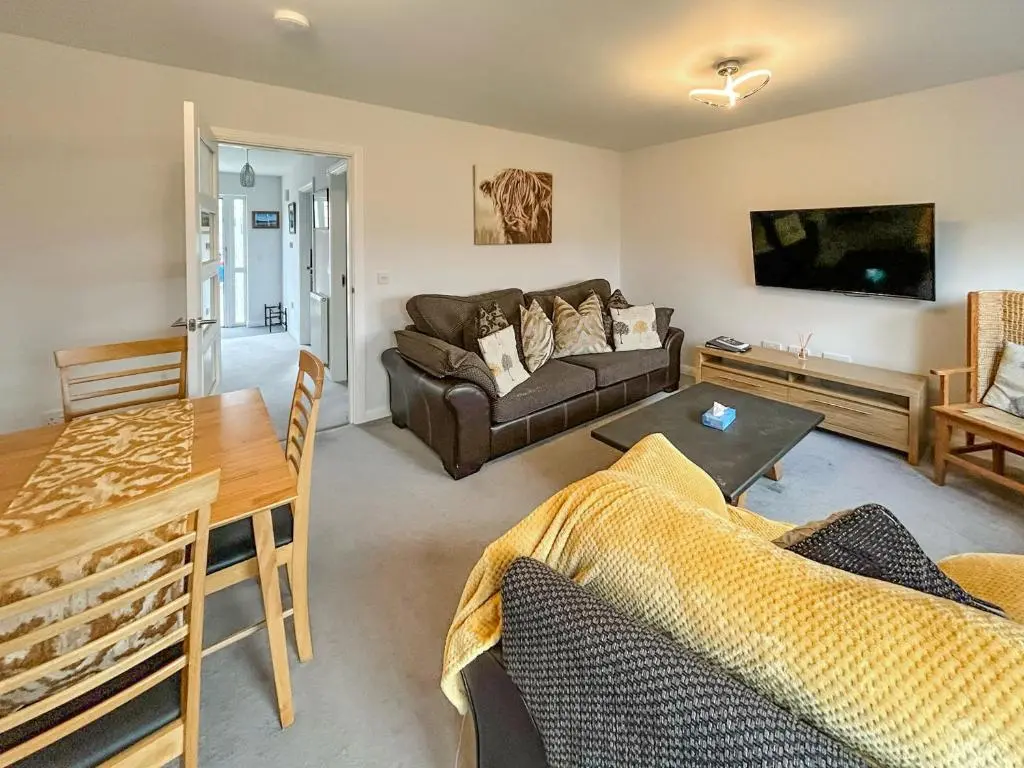 a living room with a couch and a table at Faillie in Inverness