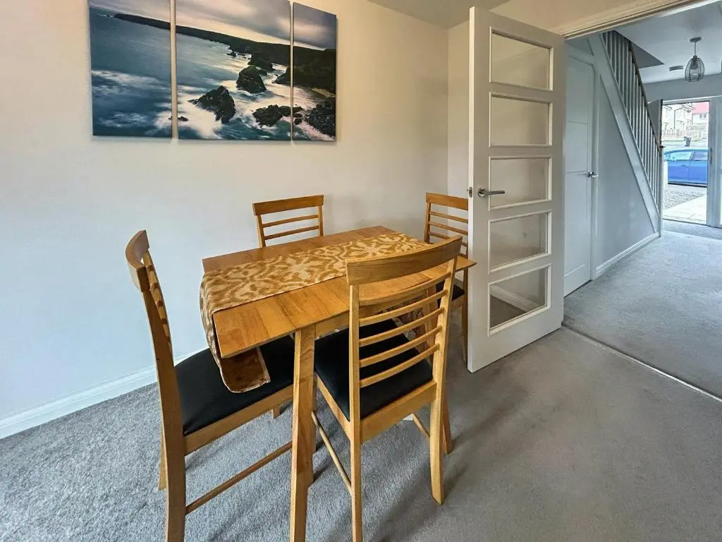 a dining room with a wooden table and chairs at Faillie in Inverness