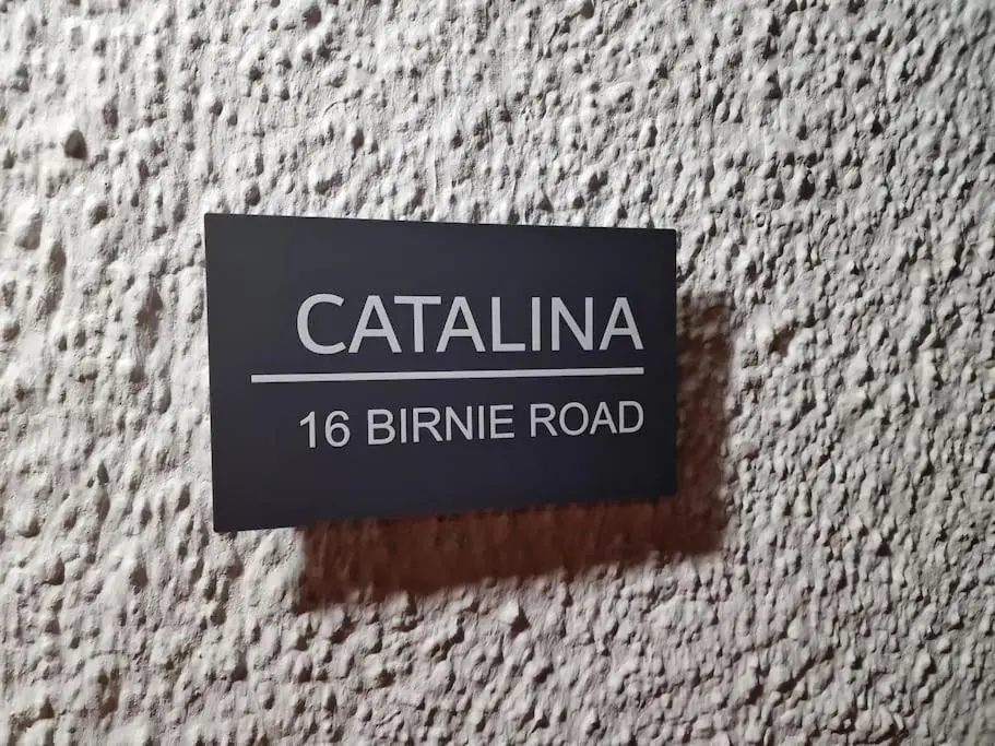 a sign on the side of a building at Catalina - Modern 2 bedroom bungalow in Elgin