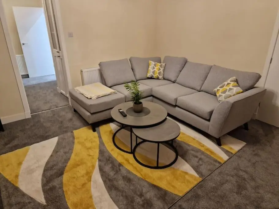 a living room with a couch and a table at Catalina - Modern 2 bedroom bungalow in Elgin