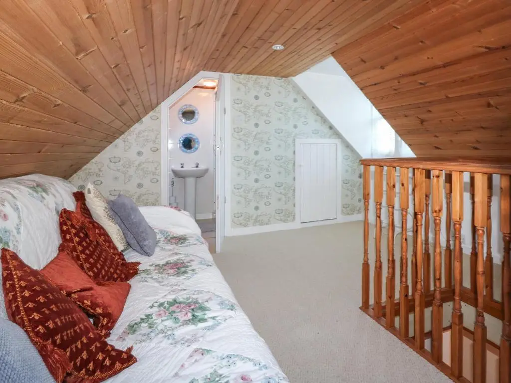 a bedroom with a bed with a wooden ceiling at 171 Seatown in Buckie