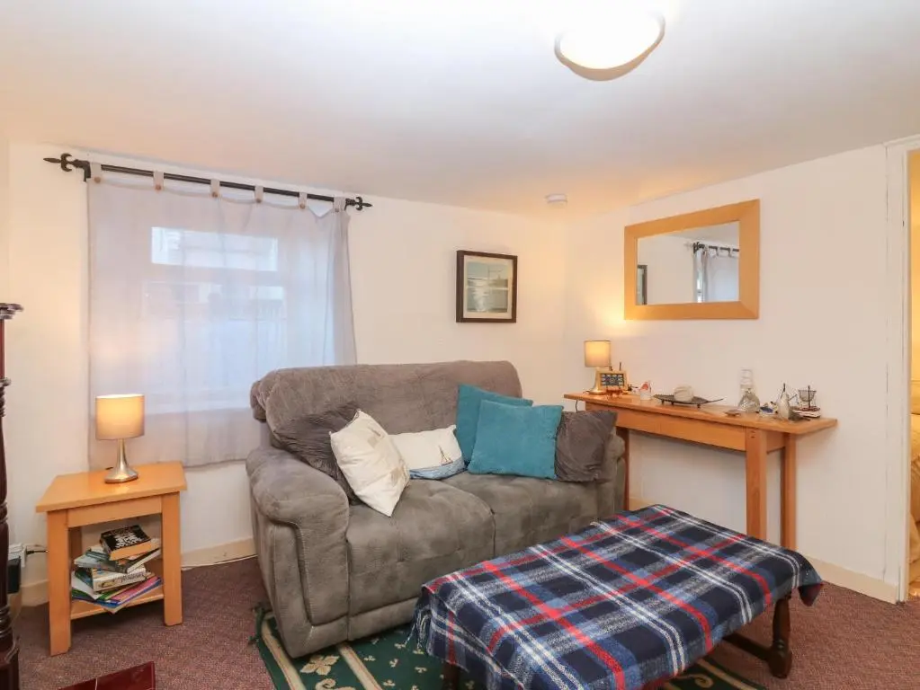 a living room with a couch and a table at 171 Seatown in Buckie