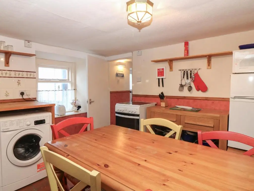 a kitchen with a wooden table and a dining room at 171 Seatown in Buckie