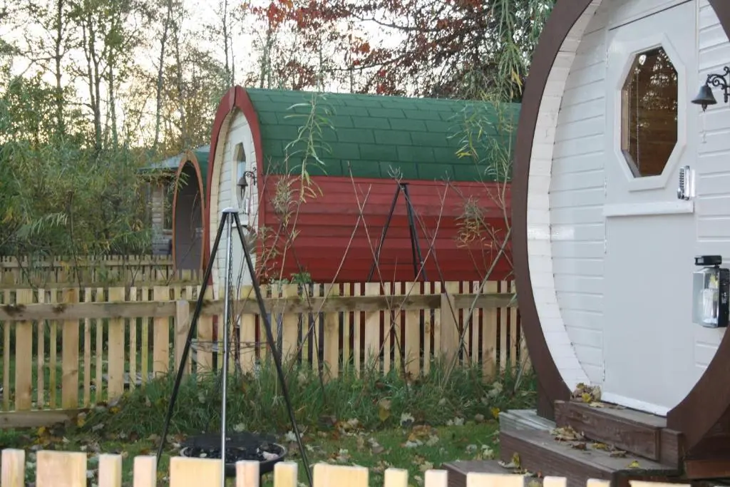 a small house with a fence and a telescope at BCC Lochness Hostel pods in Bearnock