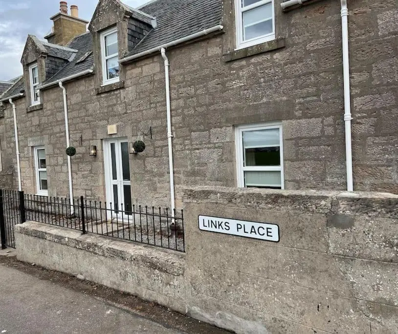 a brick building with a kings place sign on it at 1 Links Place in Nairn