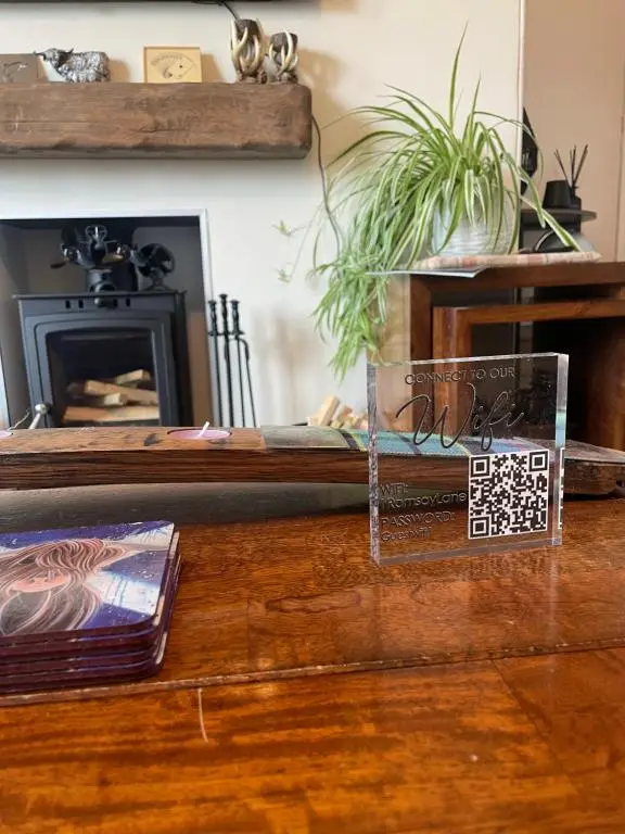 a living room with a table with a fireplace at Ramsay Lane in Lossiemouth