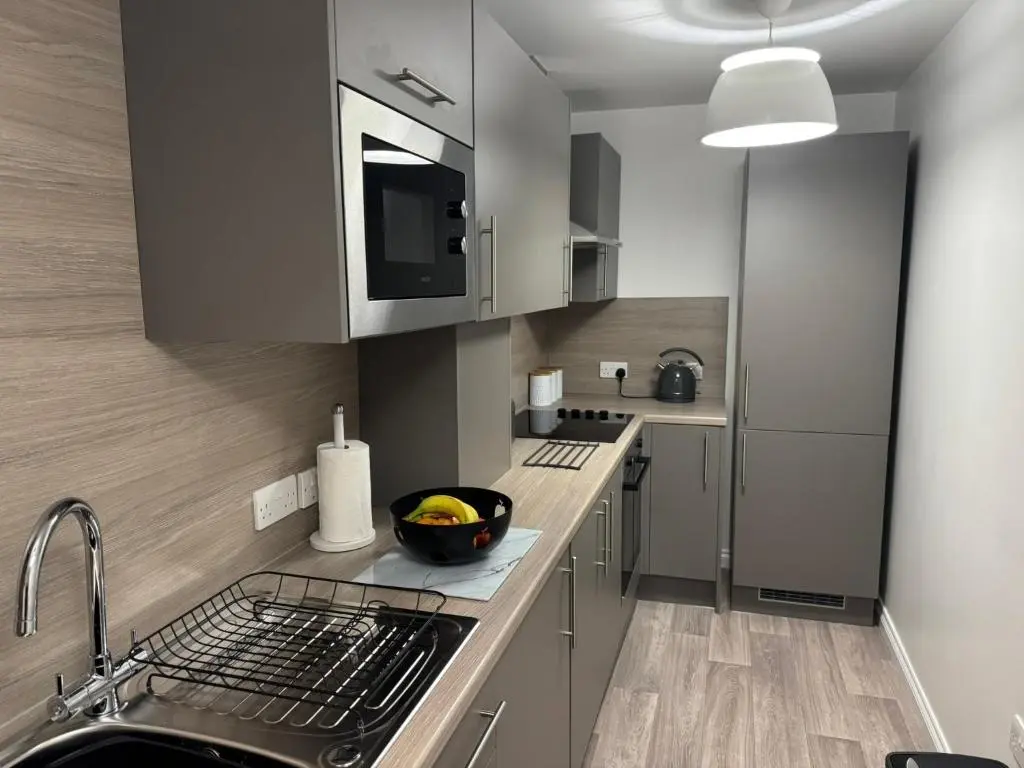a kitchen with a sink and a counter top at 20a, By The Ness in Inverness