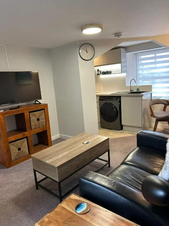 a living room with a couch and a table at 1 Bedroom Alexander Snug-Free Parking in Inverness