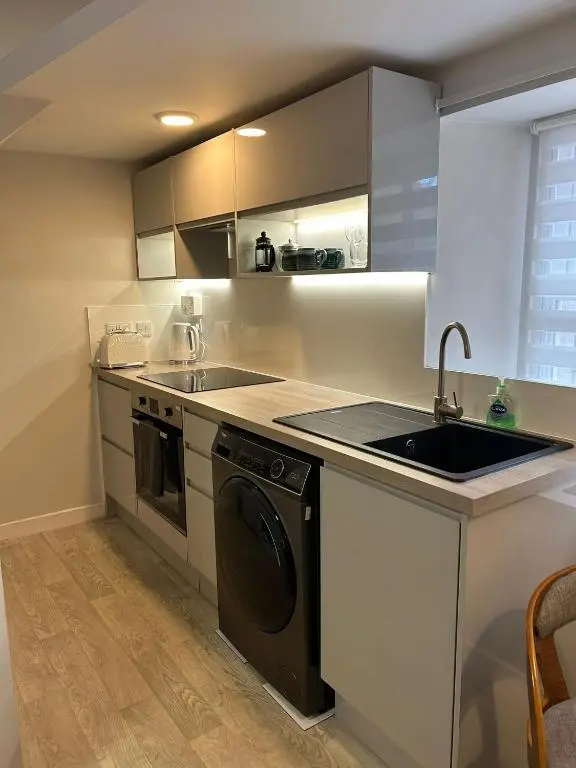 a kitchen with a sink and a dishwasher at 1 Bedroom Alexander Snug-Free Parking in Inverness