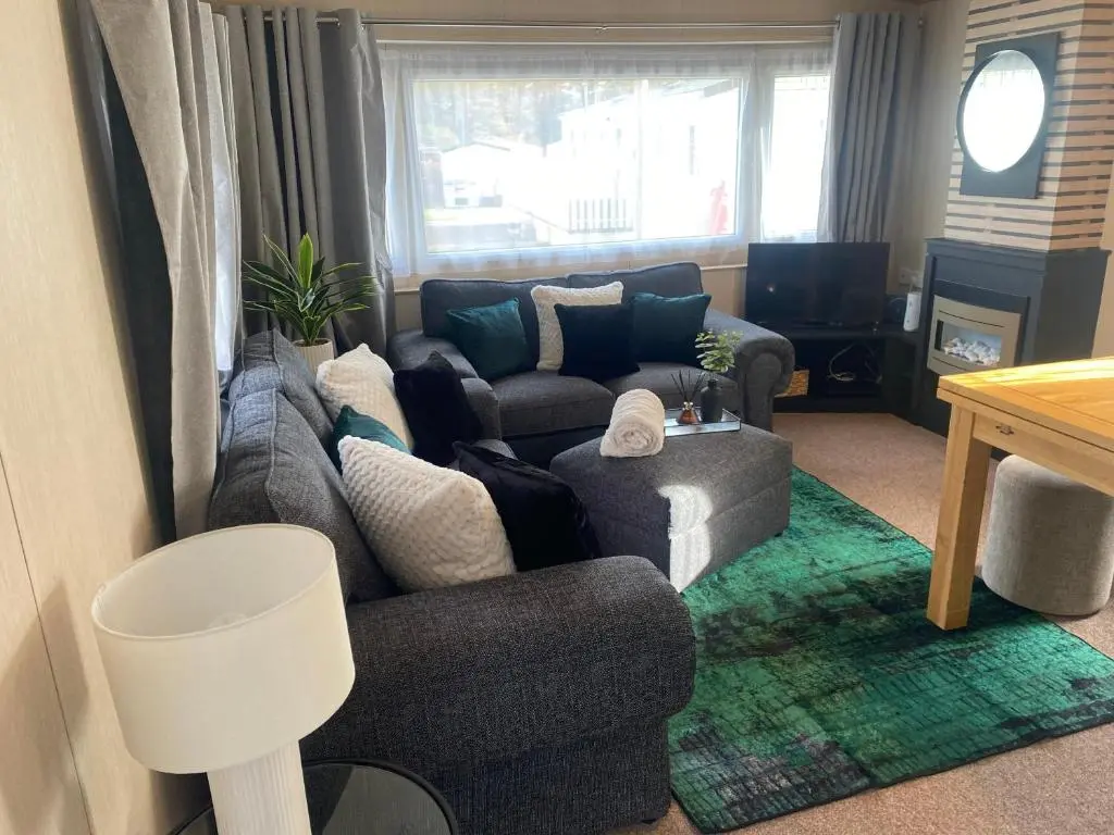 a living room with a couch and a chair at The mountain retreat in Aviemore
