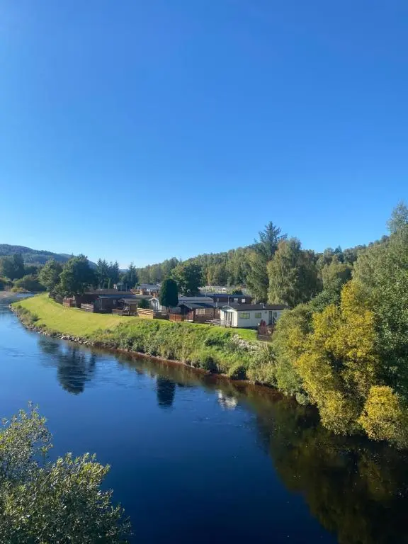 an aerial view of a river with houses at The mountain retreat in Aviemore