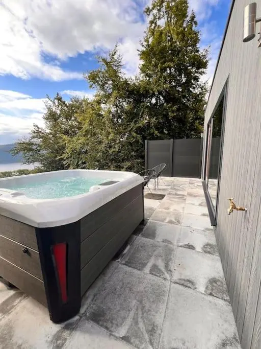 a bath tub sitting outside of a building at The Pod at Loch Ness Heights at Athbhinn, IV26TU in Inverness