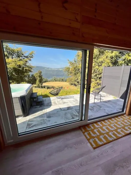 a view of a patio from a window in a house at The Pod at Loch Ness Heights at Athbhinn, IV26TU in Inverness