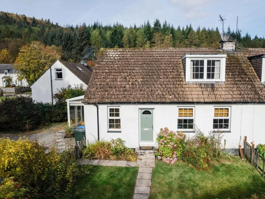 a white house with a brown roof at Holiday Home Jenkins Cottage by Interhome in Fort Augustus