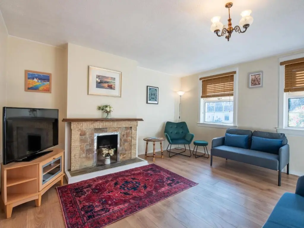 a living room with a couch and a fireplace at Holiday Home Jenkins Cottage by Interhome in Fort Augustus
