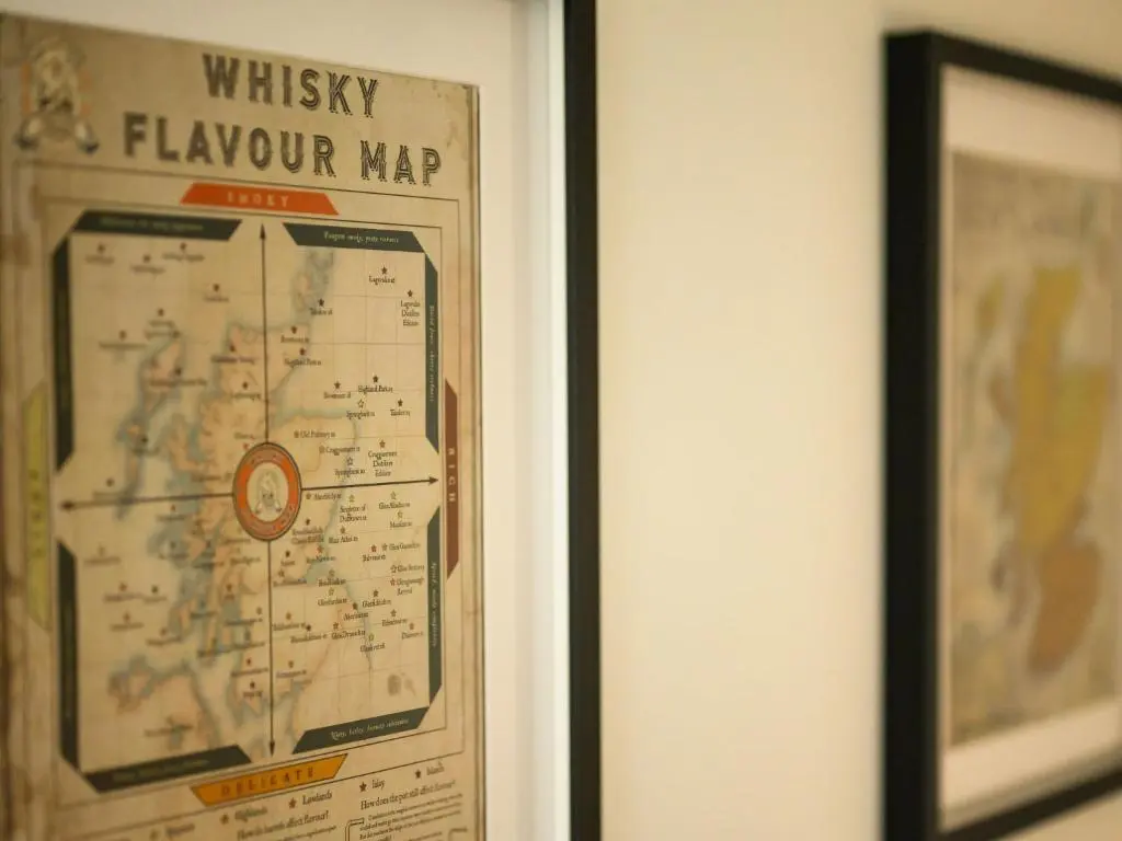 a framed map on a wall next to a picture at Apartment Craigmonie Apartment by Interhome in Drumnadrochit