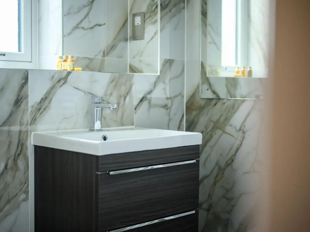 a bathroom with a sink and a mirror at Apartment Craigmonie Apartment by Interhome in Drumnadrochit