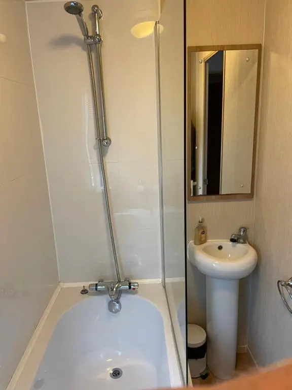 a bathroom with a sink and a tub and a toilet at Aviemore holiday park No 39 in Aviemore