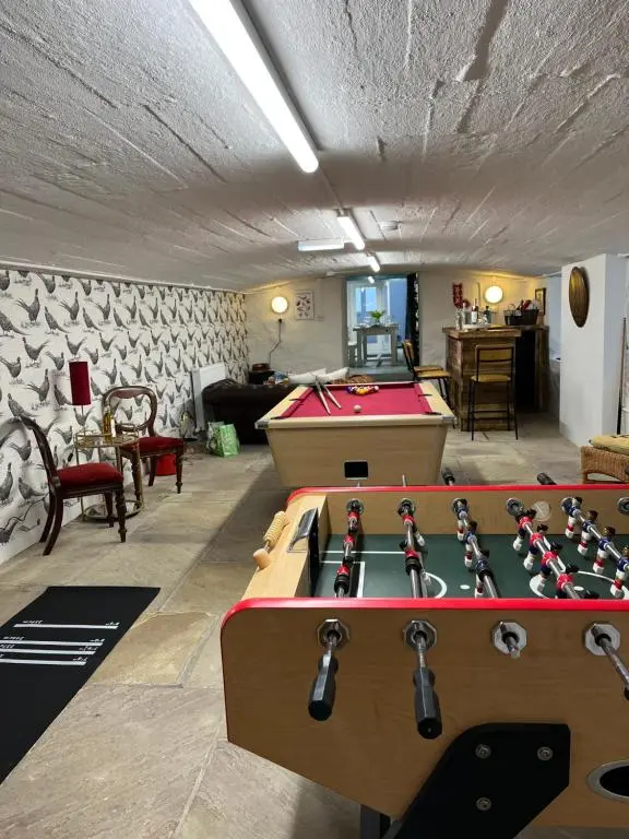 a living room with a pool table and ping pong ball at The Urquhart in Oldmeldrum