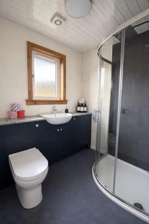 a bathroom with a toilet and a sink and a shower at Charlie's View in Inverness
