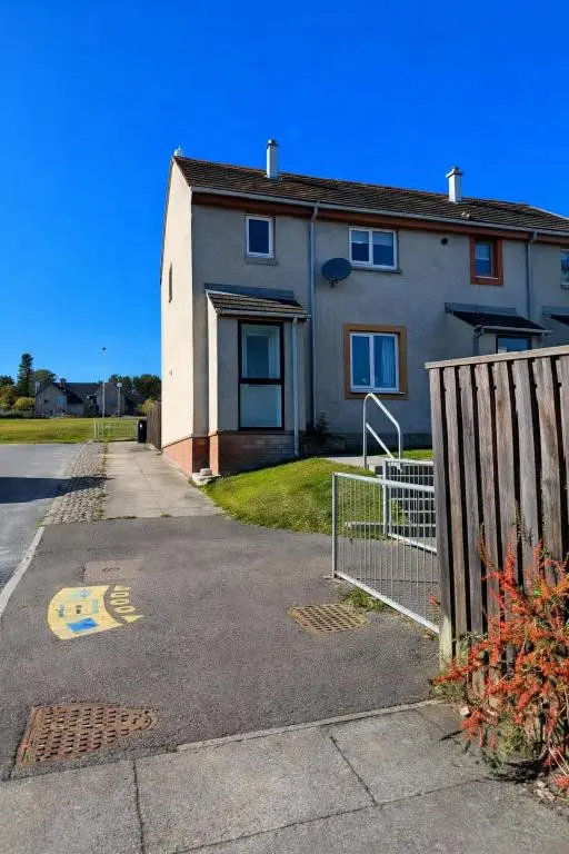a house with a fence in front of it at Charlie's View in Inverness