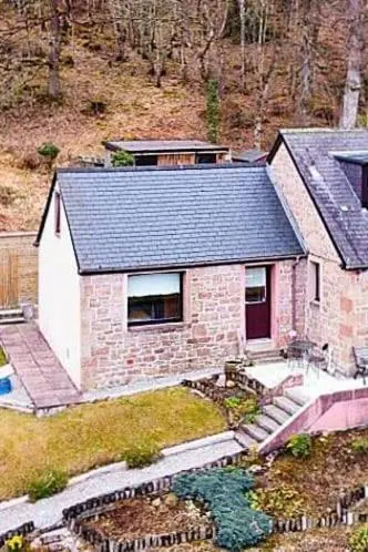an aerial view of a house on a hill at Luichart Lodge in Lochluichart Station