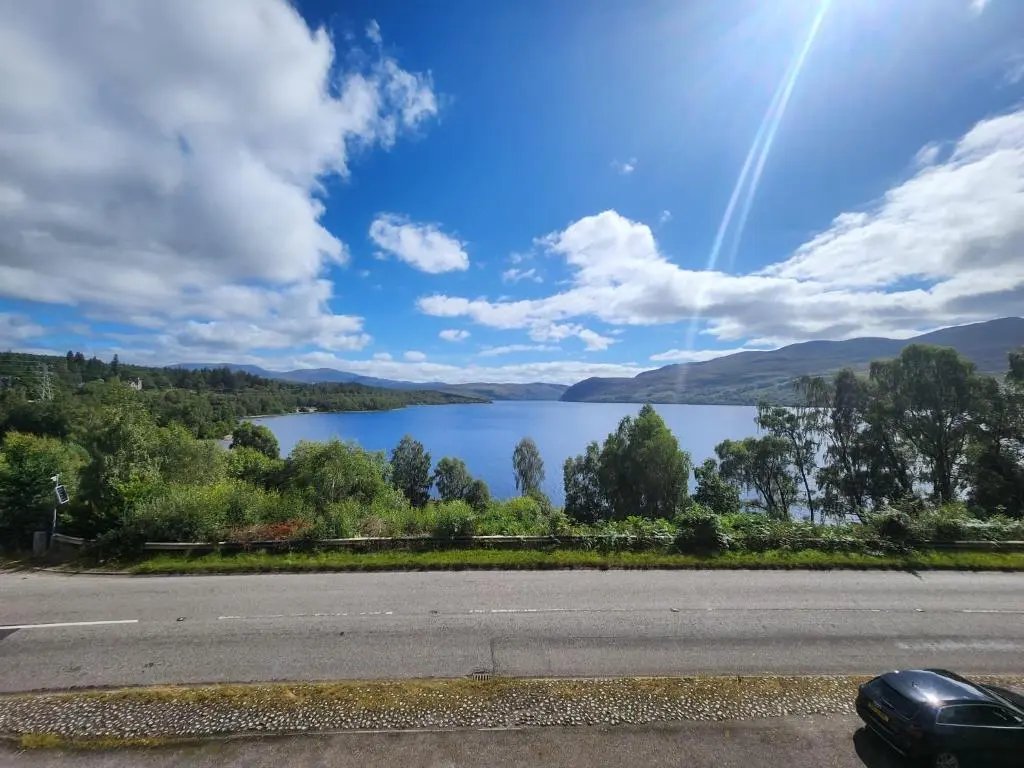 a view of a lake from the side of a road at Luichart Lodge in Lochluichart Station