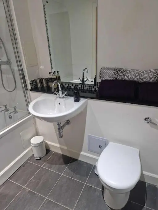 a bathroom with a toilet and a sink at Glen Mor in Fort Augustus