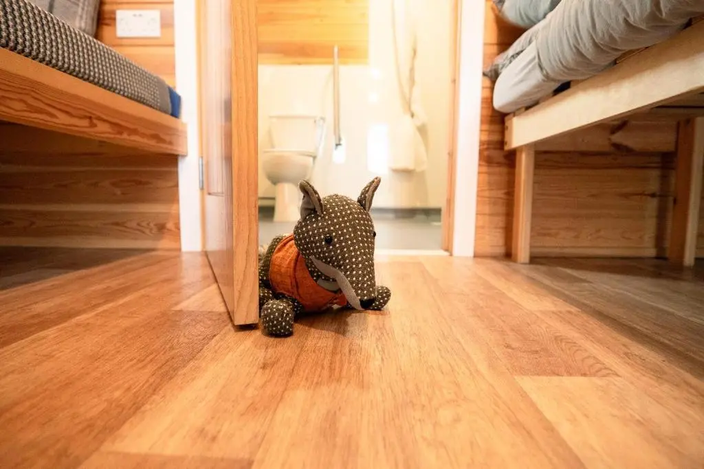 a toy rhino on the floor in a bedroom at The Loft by Wigwam Holidays in Kinloss