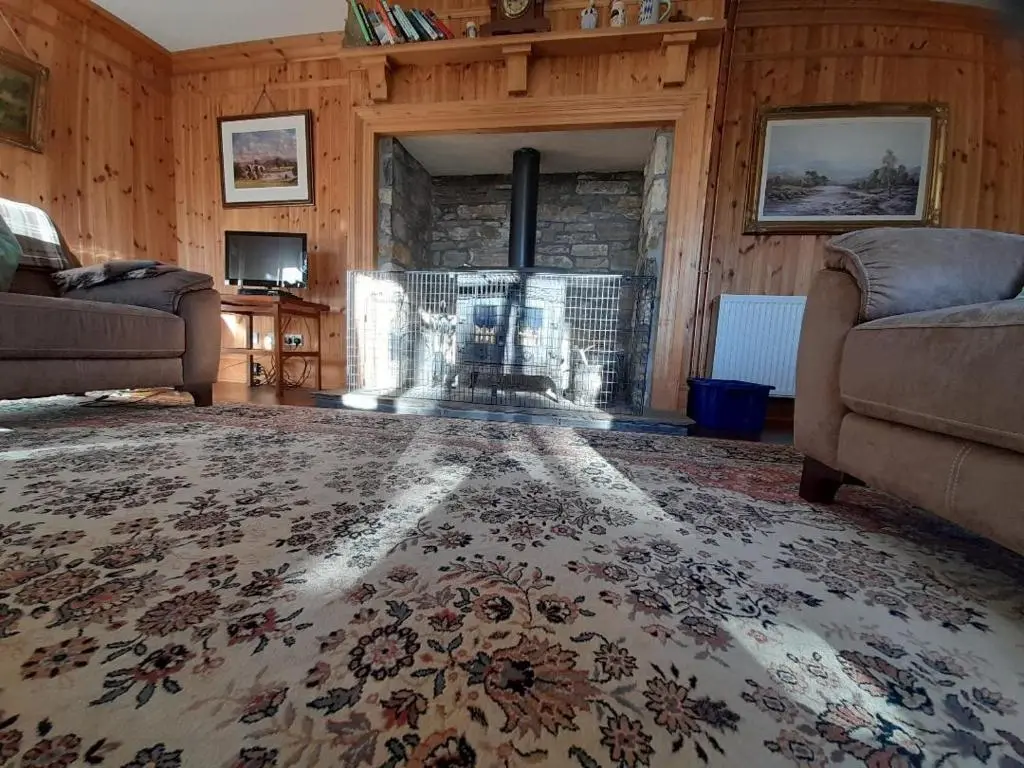 a living room with a fireplace and a couch at The Granary in Buckie