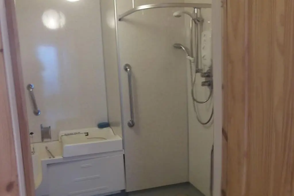 a bathroom with a shower and a sink and a shower at Taigh Sona easy access apartment with double bed in Ullapool