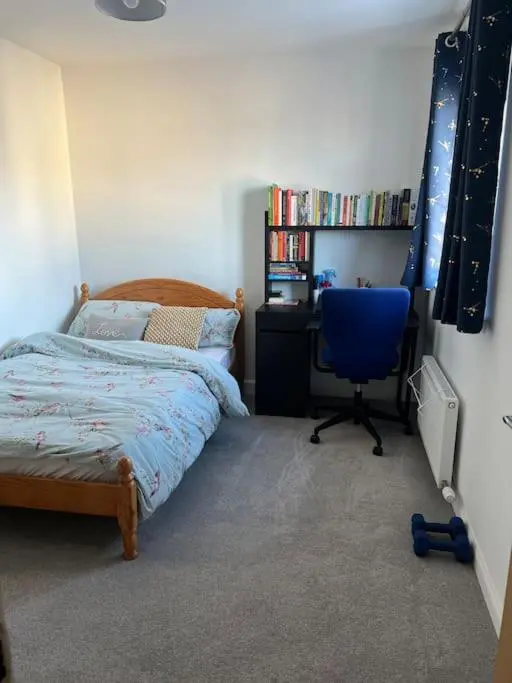 a bedroom with a bed and a desk and a chair at Lovely 2 bedroom home, free parking, 6 mins from airport in Bankhead