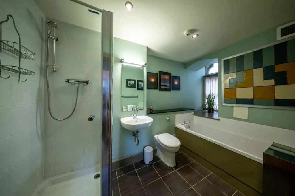 a bathroom with a sink and a toilet and a shower at Old School Refectory Highland Club in Fort Augustus