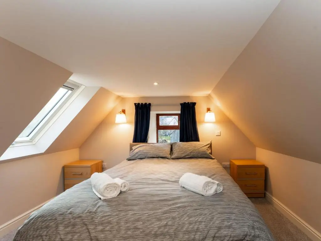 a bedroom with a bed with two towels on it at Holiday Home Rose Cottage by Interhome in Farr