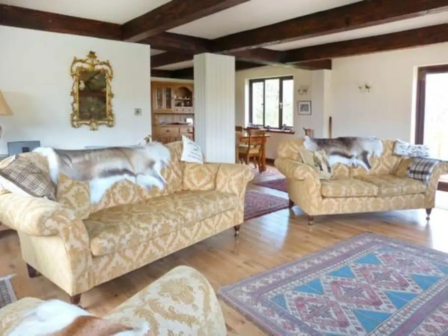 a large living room with two couches at Kerrow Burn Lodge Cannich Inverness-shire in Invercannich