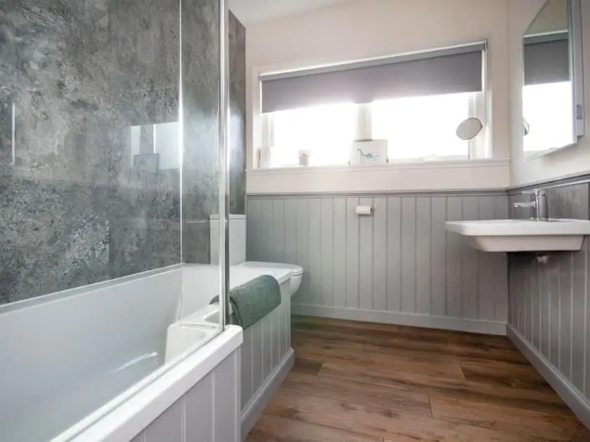 a bathroom with a shower and a sink and a tub at View Apartment in Inverness