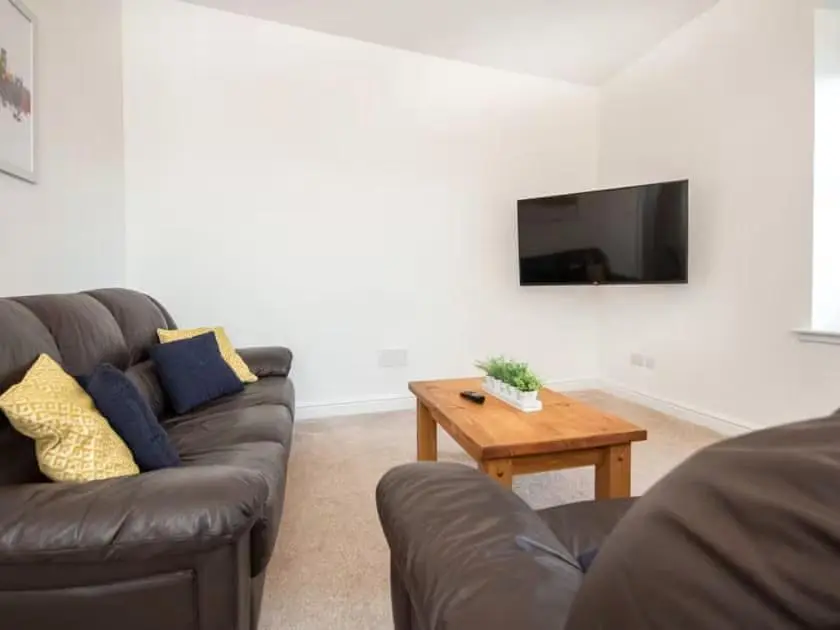 a living room with a couch and a coffee table at 4 Lower Kessock Street in Inverness