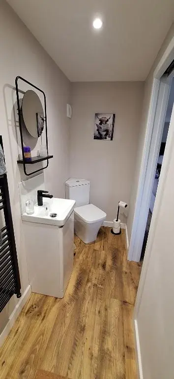 a bathroom with a white sink and a toilet at CeolMara in Ullapool