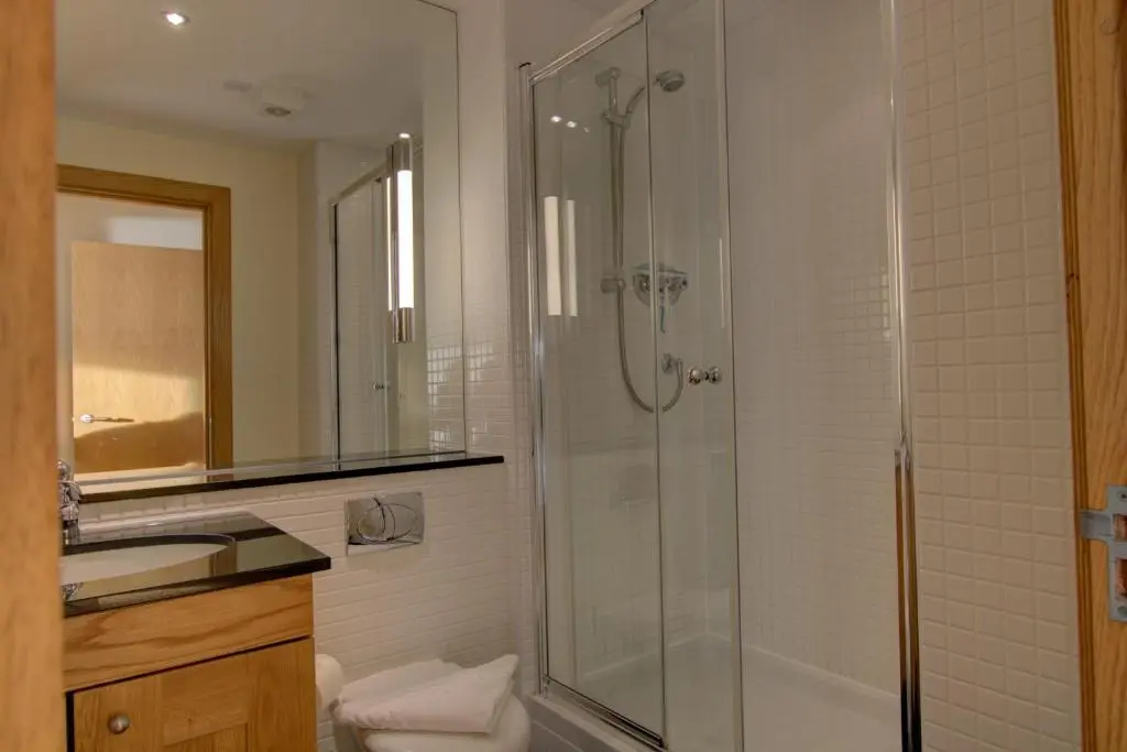 a bathroom with a shower and a sink at No10 The Links Apartment, Brora in Brora