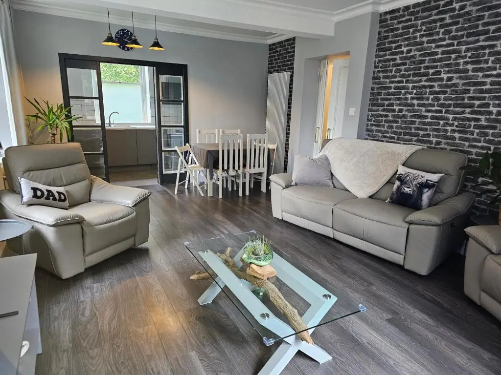 a living room with a couch and a table at Cosy highland getaway in Grantown on Spey