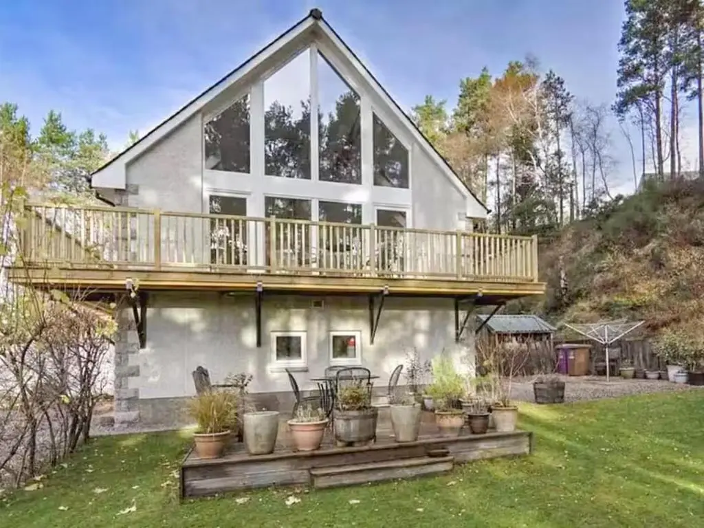 a large house with a deck on top of it at Stunning 4 bed rural retreat in Aberlour in Aberlour