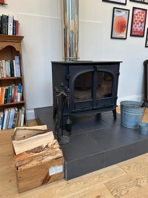 a black fireplace in a room with books at Stunning 4 bed rural retreat in Aberlour in Aberlour