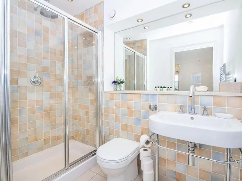 a bathroom with a toilet and a sink and a shower at 2 Bedroom Riverside Apartment 301-Free Parking in Inverness