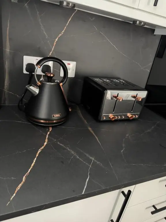 a tea kettle and a toaster on a kitchen counter at Lorna Doune in Port Elphinstone