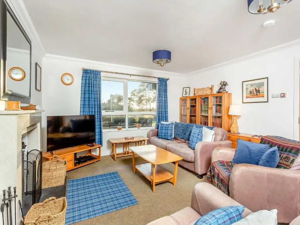 a living room with two couches and a tv at Rock Folly in Inverness