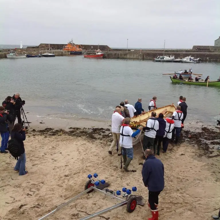 a group of people standing on the beach with a boat at 244 Seatown Cullen Moray Scotland in Cullen