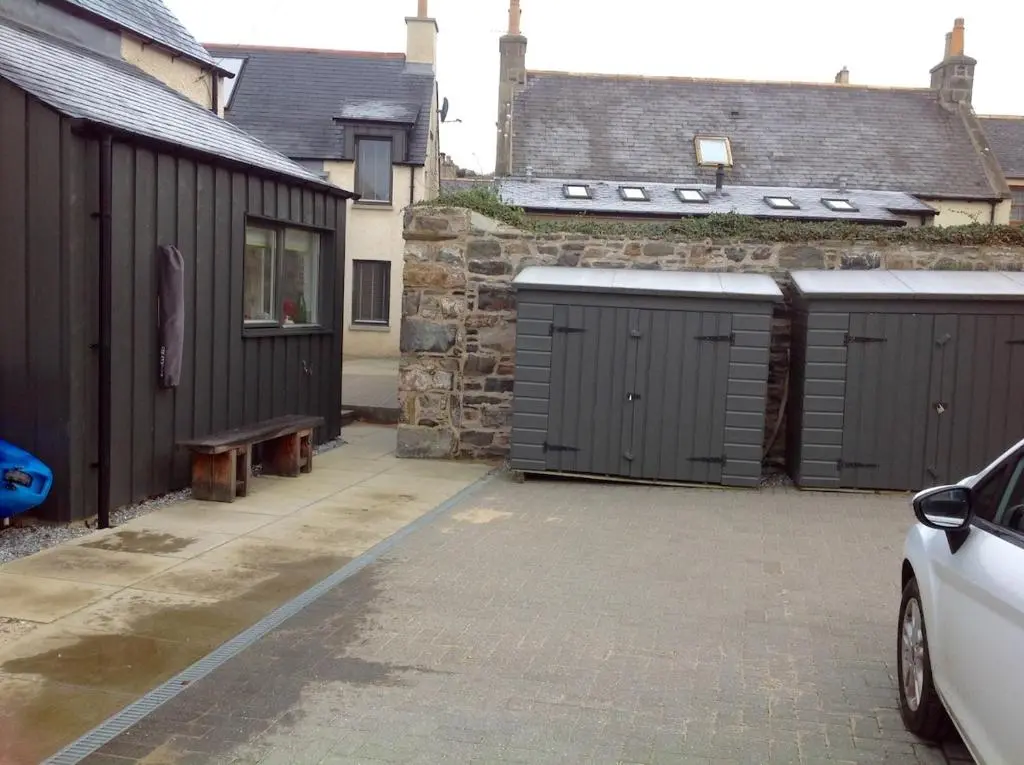 a parking lot with two garage doors and a car at 244 Seatown Cullen Moray Scotland in Cullen