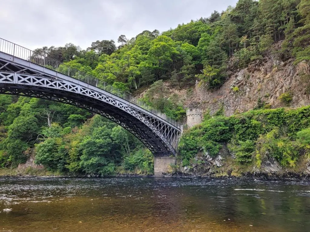 a bridge over a river next to a mountain at Bespoke Luxury Self Catering Dog Friendly Accommodation in Archiestown